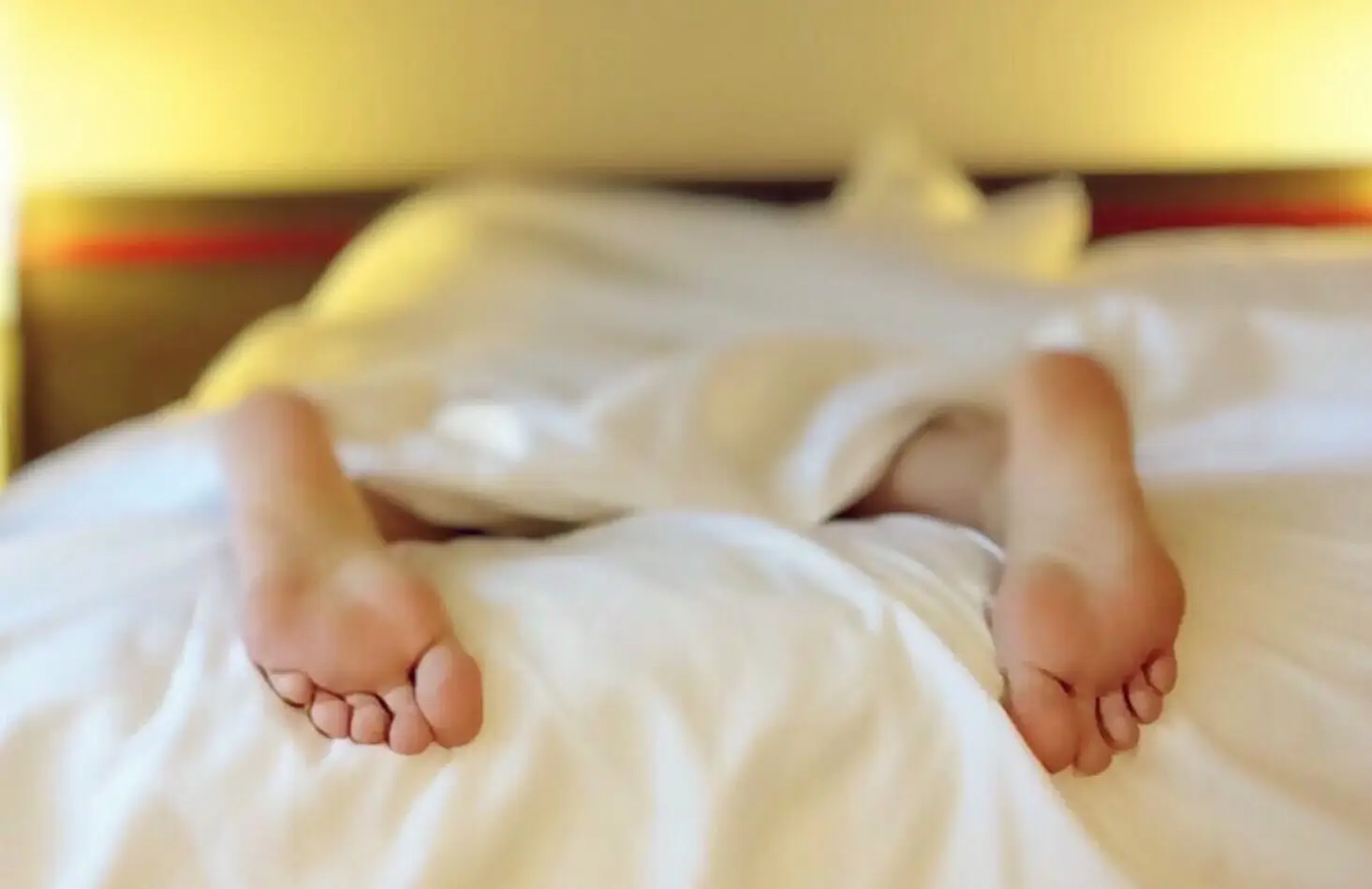 Feet poking out of bed