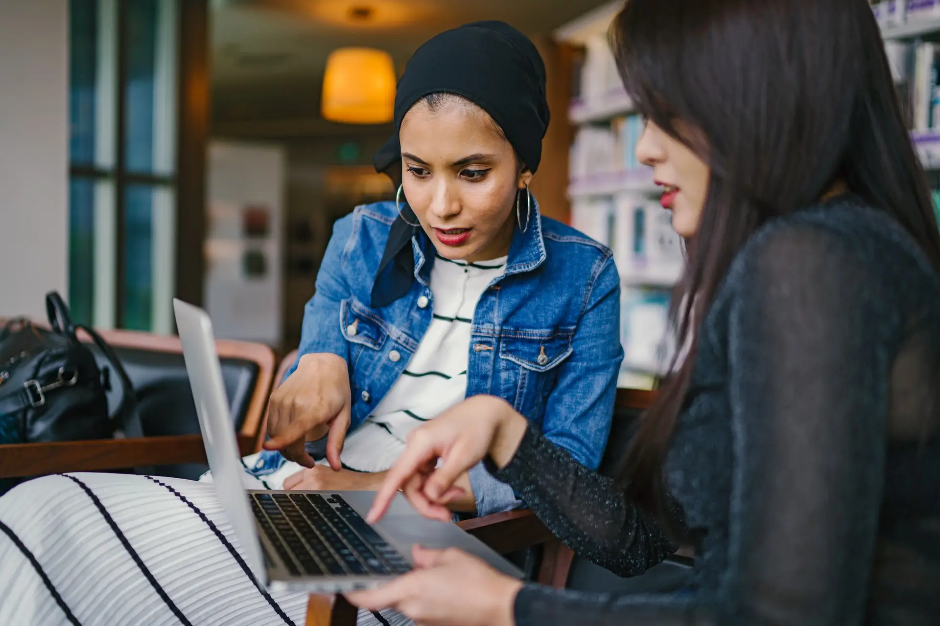 2 young women looking at screen. Photo by mentatdgt from Pexels