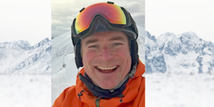 Jim Barr on ski slopes wearing snow goggles and a puffed jacket.