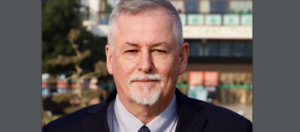 Michael Brown, Principal, Wuhan Maple Leaf High School - older white man in suit and tie with beard and mustache.