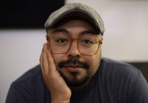 Pedro Chamale with face propped on hand and arm.