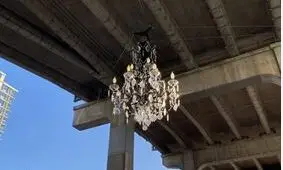 Looking up at structural underside of large concrete bridge (Granville Street Bridge north side) with "Spinning Chandelier" sculpture by Rodney Graham