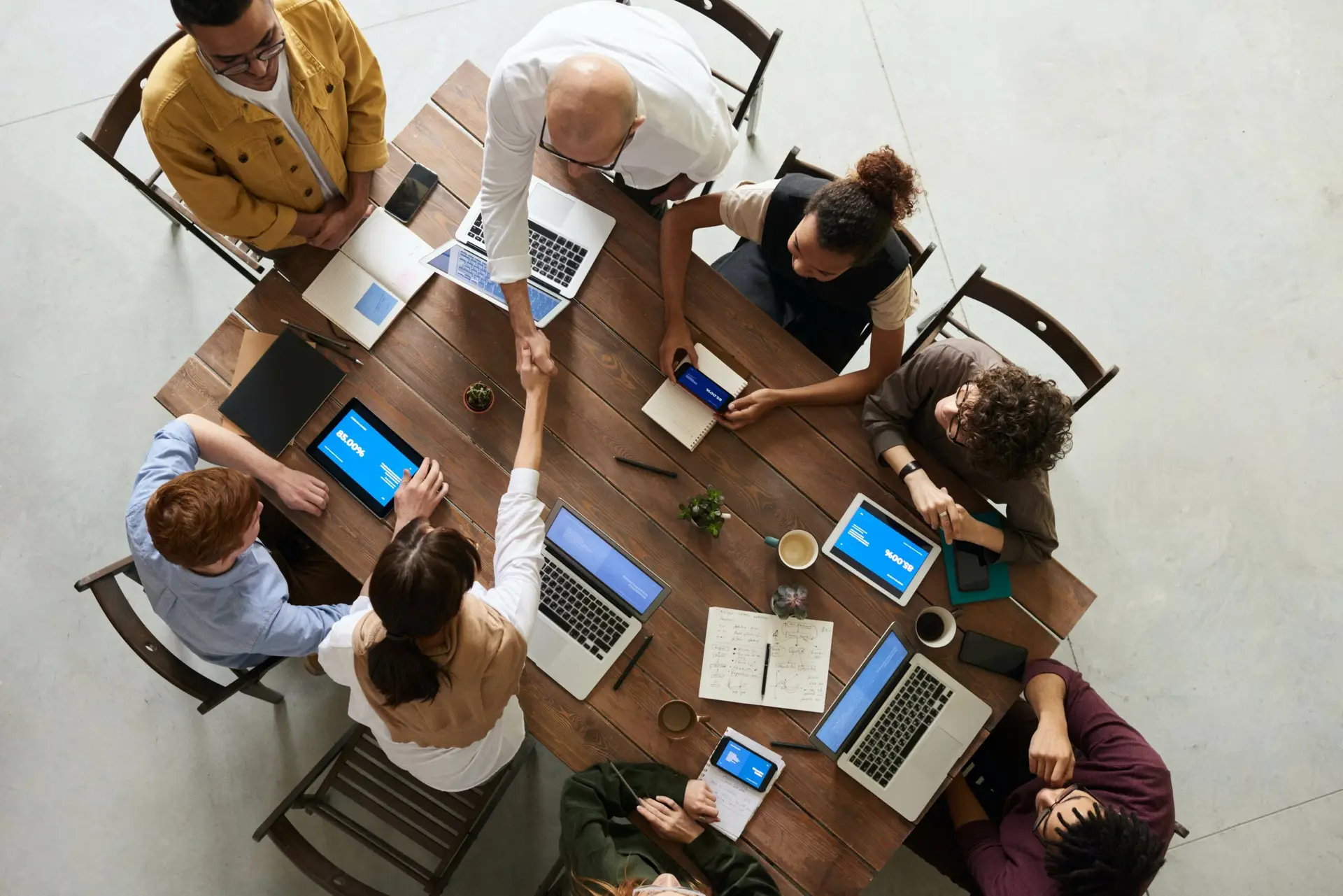 CPF Aid to Publishers 2024-2025 application, work team sitting around a table with laptops, from above