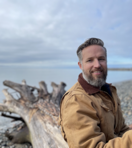 Anthony Robinson Logging & Sawmilling Journal on beach in front of tree stump