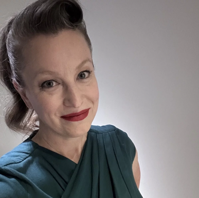 Colour headshot of Tara Cox, smiling at the camera