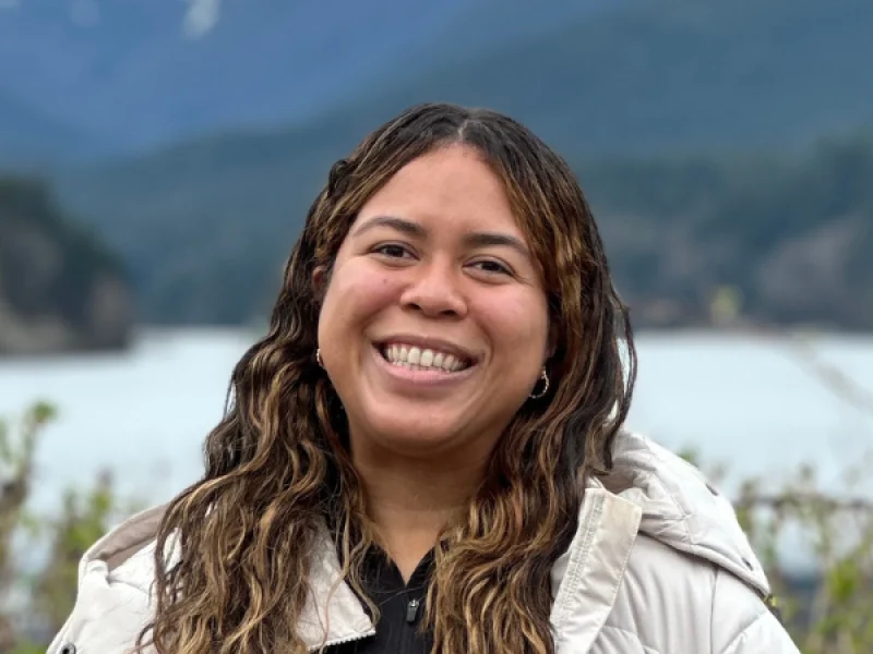 Aniana Domínguez with mountains and a lake in the background, Cleveland Park, BC, March 30, 2024. Photo by Jean Luis Pérez.
