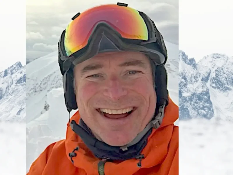 Jim Barr on ski slopes wearing snow goggles and a puffed jacket.